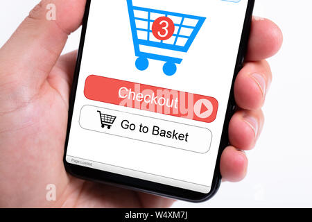 Cropped image of businesswoman's hands using smartphone with online shopping application on screen Stock Photo