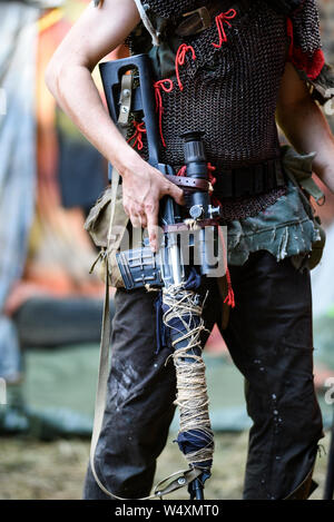 A man holding a rifle in pos apocalyptic world. Stock Photo