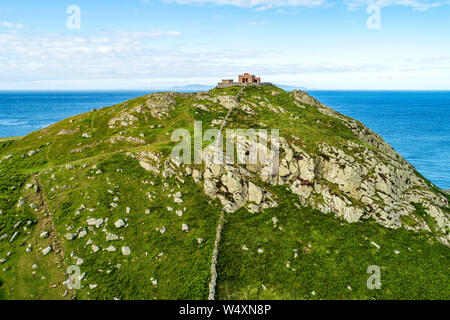 Torr Head headland, rocky cliff and peninsula with ruins of old fort in County Antrim, Northern Ireland, near Ballycastle. Aerial photo with far view