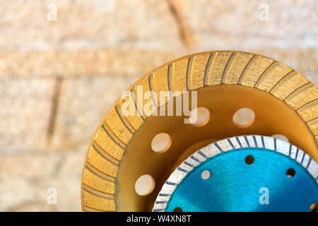 Part of the diamond grinding wheels against an orange-golden sandstone background close-up. Stock Photo