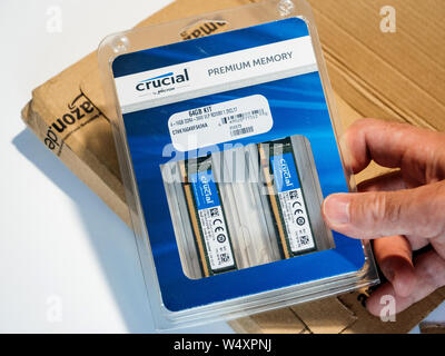 Paris, France - Jun 17, 2017: Male hand unboxing process of new Crucial Premium Memory for workstation 64gb kit model 4-16gb ddr4- 2400 vlp rdimm 1,2 cvl 17 to be used in professional servers and workstation Stock Photo