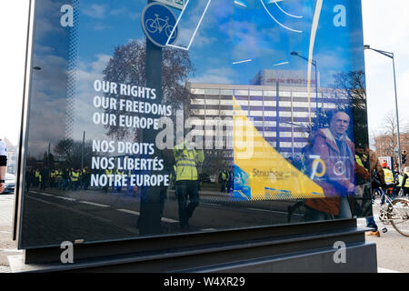 STRASBOURG, FRANCE - FEB 02, 2018: Reflection of People marching during protest of Gilets Jaunes manifestation anti-government demonstrations in Our Rights, Freeedom Europe banner Council of Europe Stock Photo