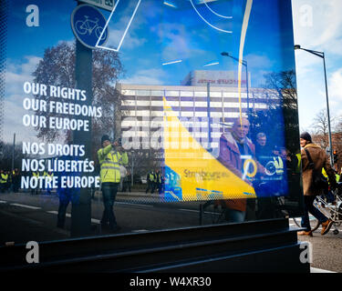 STRASBOURG, FRANCE - FEB 02, 2018: Reflection of People marching during protest of Gilets Jaunes manifestation anti-government demonstrations in Our Rights, Freeedom Europe banner Council of Europe Stock Photo