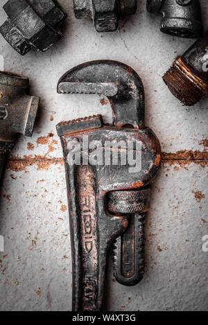 Rusty pipe wrench on white texture background Stock Photo