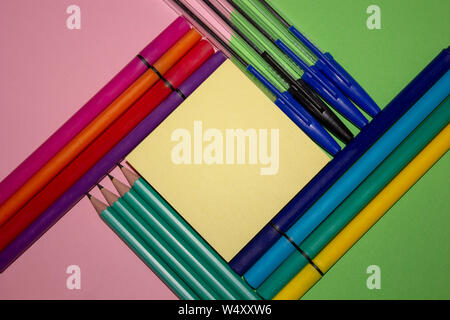 Several stationary supplies arranged in an aesthetically pleasing way. Pens, pencils, markers, note taking. Stock Photo
