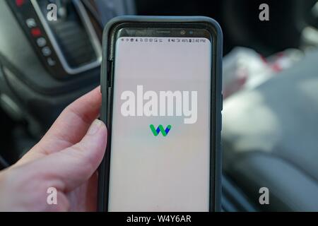 Close-up of hand of a man holding a smartphone with the Waymo app, under testing for future use in calling self driving taxis from driverless transport company Waymo, a subsidiary of Google Inc parent company Alphabet, in the Silicon Valley, Mountain View, California, May 3, 2019. () Stock Photo