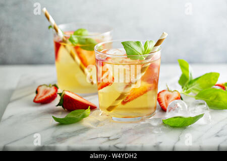 Iced green tea with strawberries and basil Stock Photo