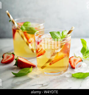 Iced green tea with strawberries and basil Stock Photo