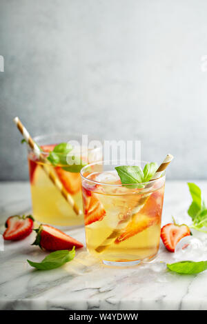 Iced green tea with strawberries and basil Stock Photo