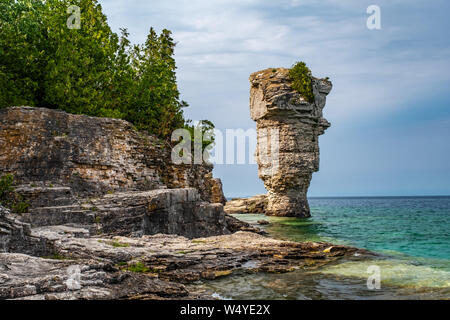On Flowerpot island in Fathom Five National Marine Park, one of the two rock pillars or sea stacks, rise from the waters of Georgian Bay. Stock Photo