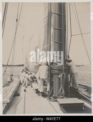 Crew handling sail on the yacht Reliance, winner of 1903 America's Cup Stock Photo