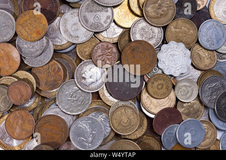pile of coins different currencies as background Stock Photo