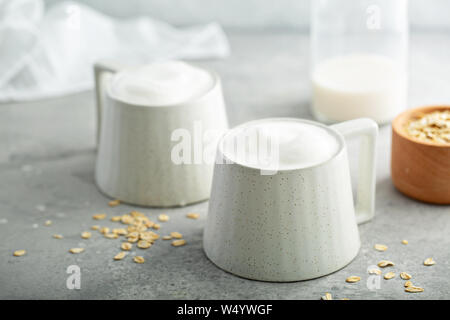 Oat milk latte with thick foam in ceramic mugs Stock Photo
