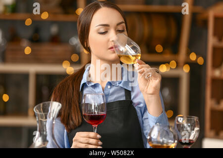 Female sommelier working in wine cellar Stock Photo