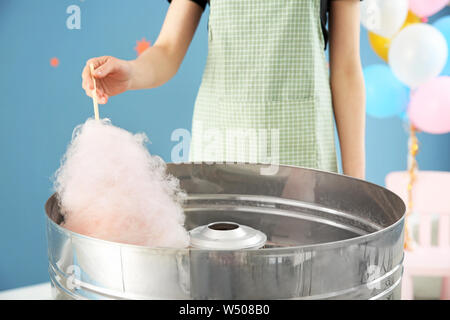 Woman making cotton candy at fair Stock Photo