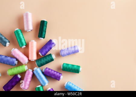 Many sewing threads on color background Stock Photo