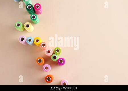 Many sewing threads on color background Stock Photo