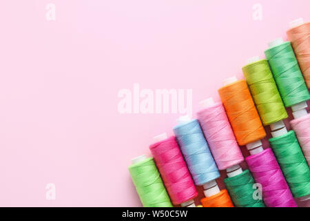 Many sewing threads on color background Stock Photo