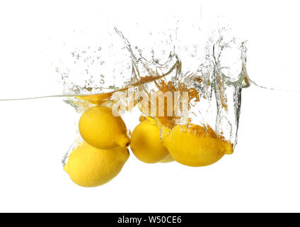 Falling of lemons into water on white background Stock Photo