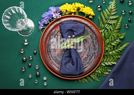 Beautiful table setting with floral decor on color background Stock Photo