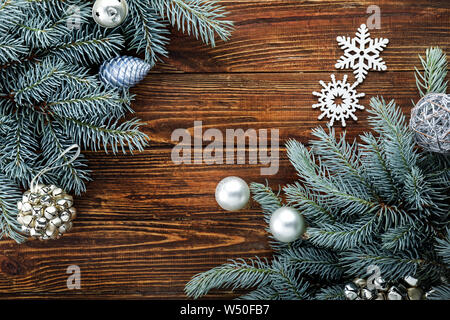 Fir branches with Christmas decor on wooden background Stock Photo