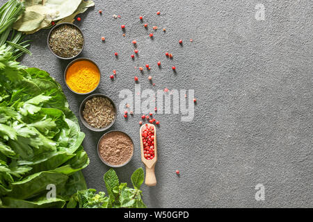 Different herbs and spices on grey background Stock Photo