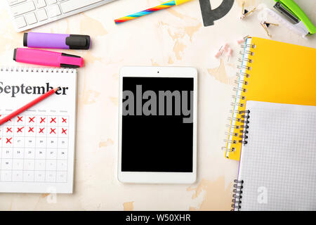 Modern tablet computer and stationery on light background Stock Photo
