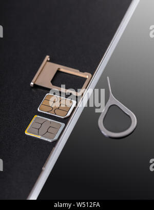 mobile phone and sim card on a black background Stock Photo