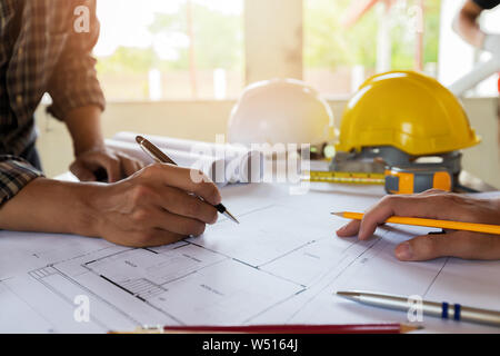 An architect or engineer writing on blueprint, architectural concept Stock Photo
