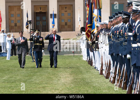 U.S. President Donald J. Trump and Secretary of Defense Dr. Mark T. Esper review the troops with the commander of the troops, Army Col. James J. Tuite, during a Full Honors Welcome Ceremony for Esper, at the Pentagon, Washington, D.C., July 25, 2019. (DoD photo by Lisa Ferdinando) Stock Photo