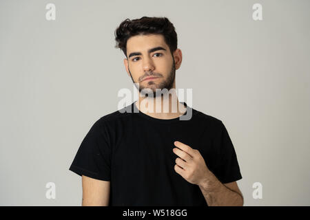 Close up of young thoughtful latin man looking worried and upset thinking in a solution to a problem. In people human facial expressions and emotions. Stock Photo