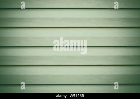 Light green wooden background in lines. Striped texture. Planks timber backdrop. Gray panel, wood surface. Grey painted boards. Oak fence. Copy space. Stock Photo