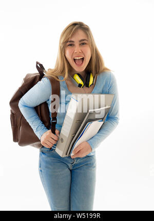 Beautiful teenager girl or young college student woman with backpack and folder smiling feeling happy and cheerful. Isolated on white background. Univ Stock Photo