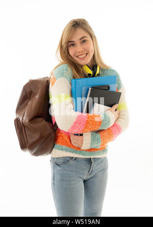 Portrait of beautiful teenager girl with backpack and notepad folder smiling against white background. Young college teen woman happy to start univers Stock Photo