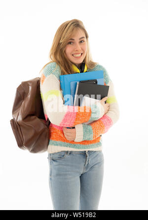 Portrait of beautiful teenager girl with backpack and notepad folder smiling against white background. Young college teen woman happy to start univers Stock Photo
