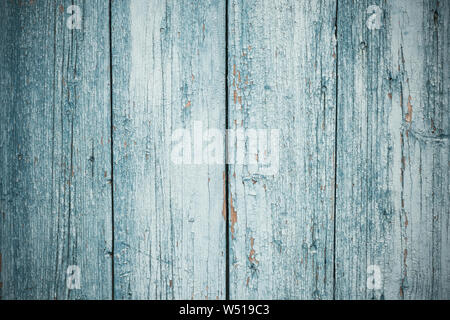 Old gray wood background in vintage style. Space texture. Design element. Green wooden door. Vertical lines on blue painted fence, grunge. Peeling har Stock Photo