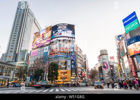 Shibuya Crossing, crossing with many pedestrians, many shopping centers and shops, illuminated advertising on skyscrapers, Shibuya, Tokyo, Japan Stock Photo