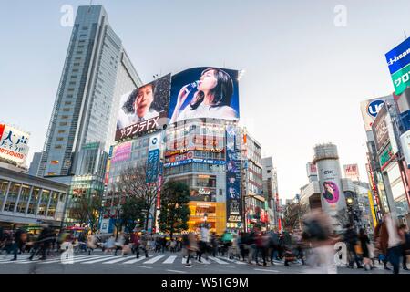 Shibuya Crossing, crossing with many pedestrians, many shopping centers and shops, illuminated advertising on skyscrapers, Shibuya, Tokyo, Japan Stock Photo