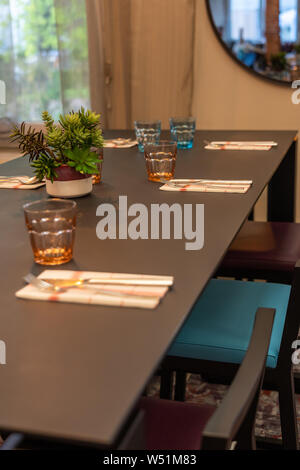 Colorful glasses and well-decorated dining table at home Stock Photo