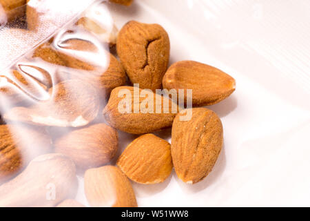 almonds packages in plastic packaging isoalted on white background Stock Photo