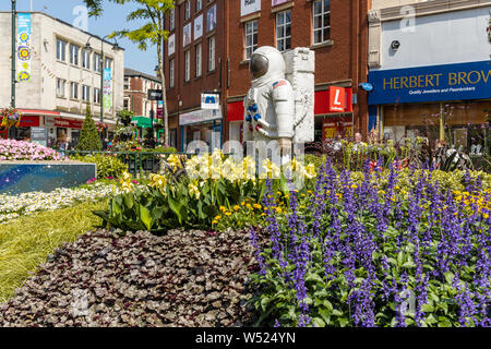 Alien landscape with American astronauts landing on the Moon theme community garden in the middle of town in North West of England. Stock Photo