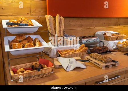 Assorted fresh pastry on table in breakfast buffet in hotel Stock Photo