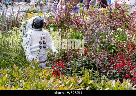Alien landscape with American astronauts landing on the Moon theme community garden in the middle of town in North West of England. Stock Photo