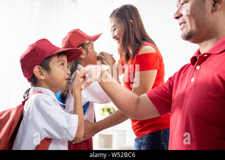 student kiss his parent's hand before going to school Stock Photo