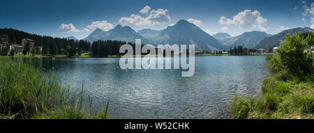 Arosa, GR / Switzerland - 24. July, 2019: panorama landscape view of the lake and town of Arosa in the Swiss Alps Stock Photo