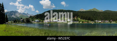 Arosa, GR / Switzerland - 24. July, 2019: panorama landscape view of the lake and town of Arosa in the Swiss Alps Stock Photo