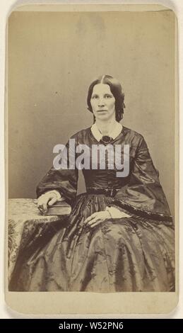Unidentified woman seated, resting a hand on a book on a table, L.T. Sparhawk (American, active West Randolph, Vermont 1860s - 1900s), 1870–1879, Albumen silver print Stock Photo