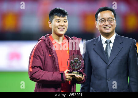 Li Ying of Chinese women's national football team, left, earns the Best Shooter Award after defeating South Korea in the final of the CFA Team China I Stock Photo