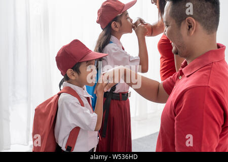 student kiss his parent's hand before going to school Stock Photo