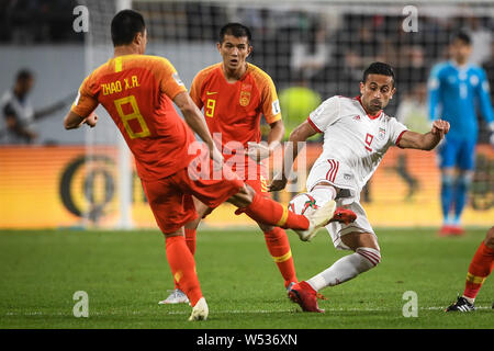 Omid Ebrahimi of Iran, right, dribbles against Zhao Xuri of China in their quarter-final match during the 2019 AFC Asian Cup in Abu Dhabi, United Arab Stock Photo